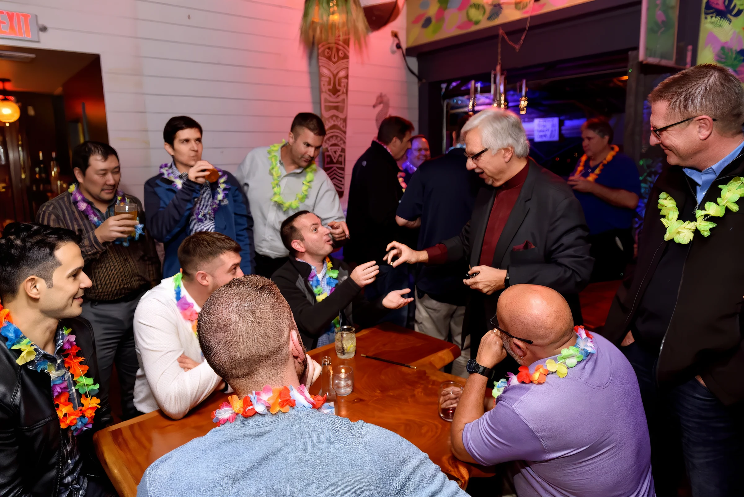 Jim Sisti performing close-up magic surrounded by an engaged audience